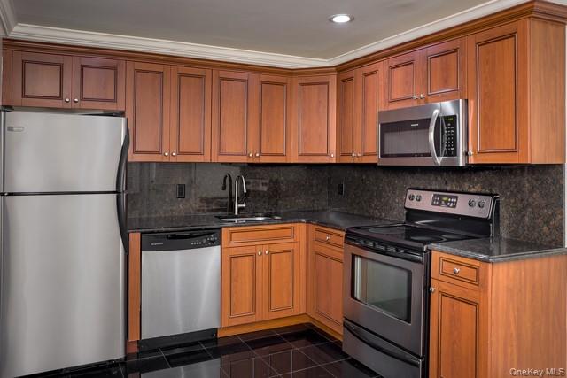 58 Horseblock Road, Unit 582A Centereach, NY 11720 - Photo 2 of 8 a kitchen with stainless steel appliances granite countertop a refrigerator stove top oven and sink