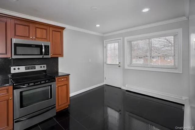 a kitchen with wooden cabinets and a stove top oven