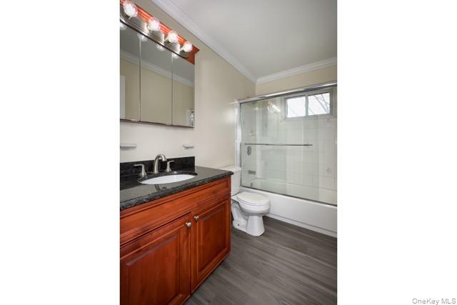 58 Horseblock Road, Unit 582A Centereach, NY 11720 - Photo 8 of 8 a bathroom with a toilet sink and mirror