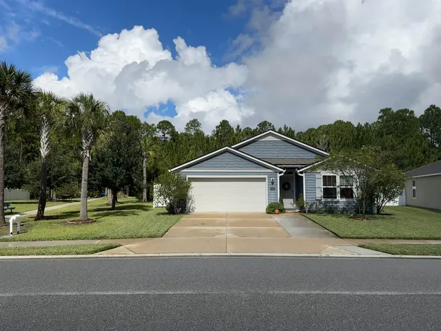 a house with a big yard and large trees