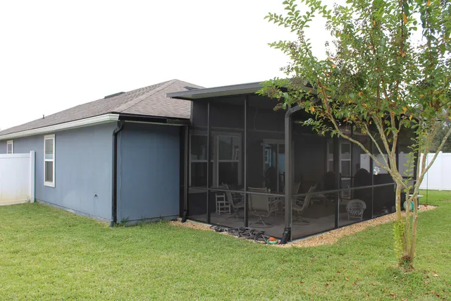 a view of brick house with potted plants