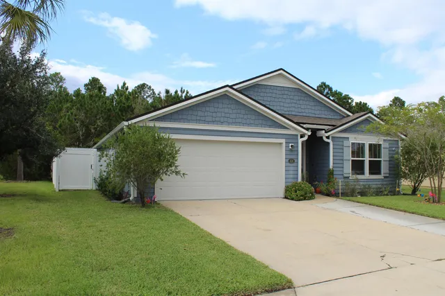 a front view of a house with a garden and plants