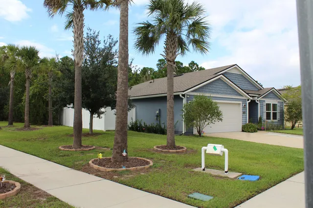a front view of house with yard and green space