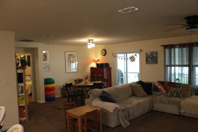 a kitchen with refrigerator and chairs