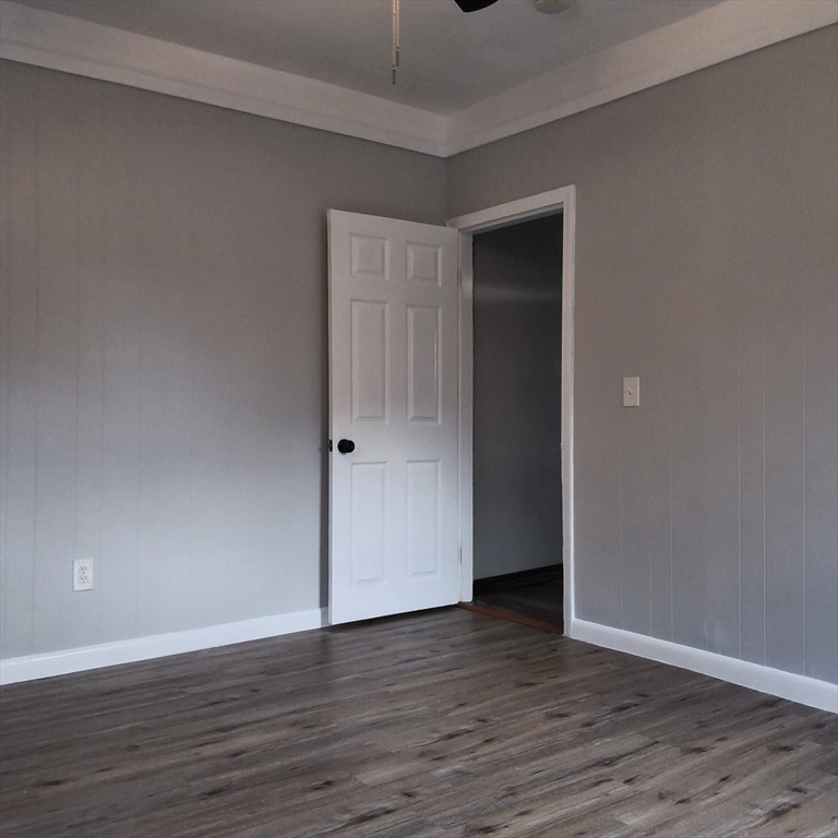 212-218 Lowell Street, Unit 1E Fall River, MA 02721 - Photo 6 of 10 a view of an empty room with wooden floor and closet
