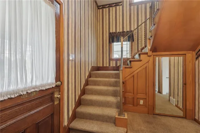 a view of entryway with wooden floor and stairs