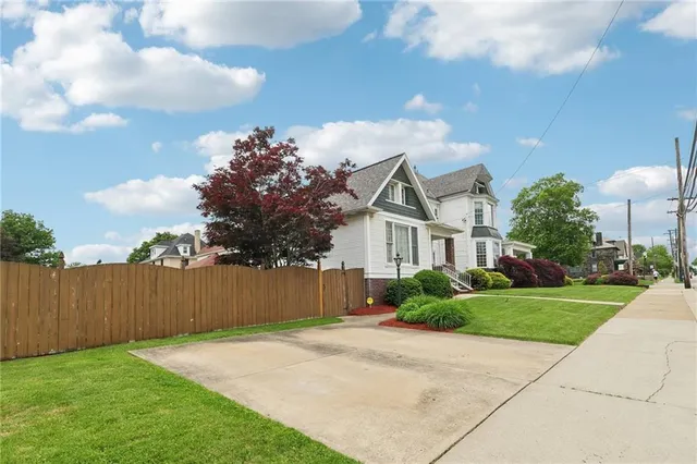 a front view of a house with a yard and a garage