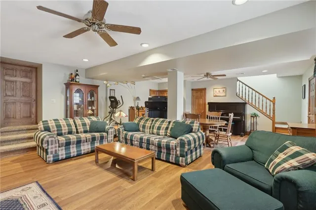 a living room with furniture or couch and a ceiling fan