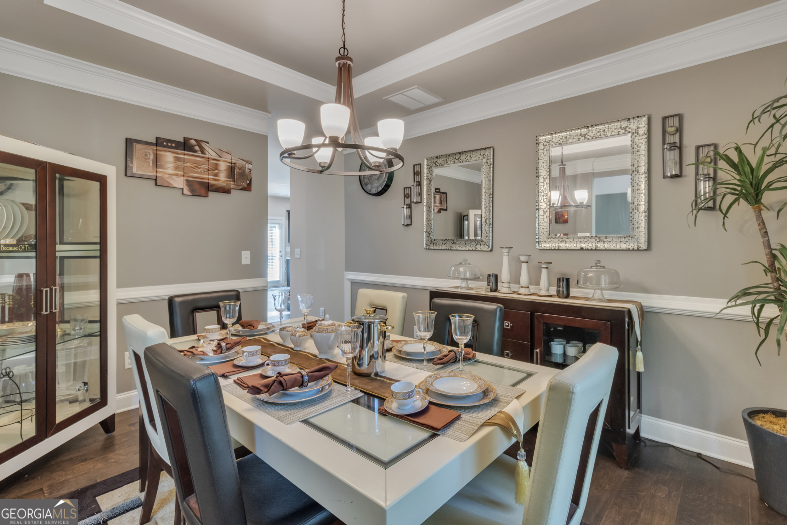 11614 Alcovy Road Covington, GA 30014 - Photo 13 of 62 a view of a dining room with furniture a chandelier and wooden floor