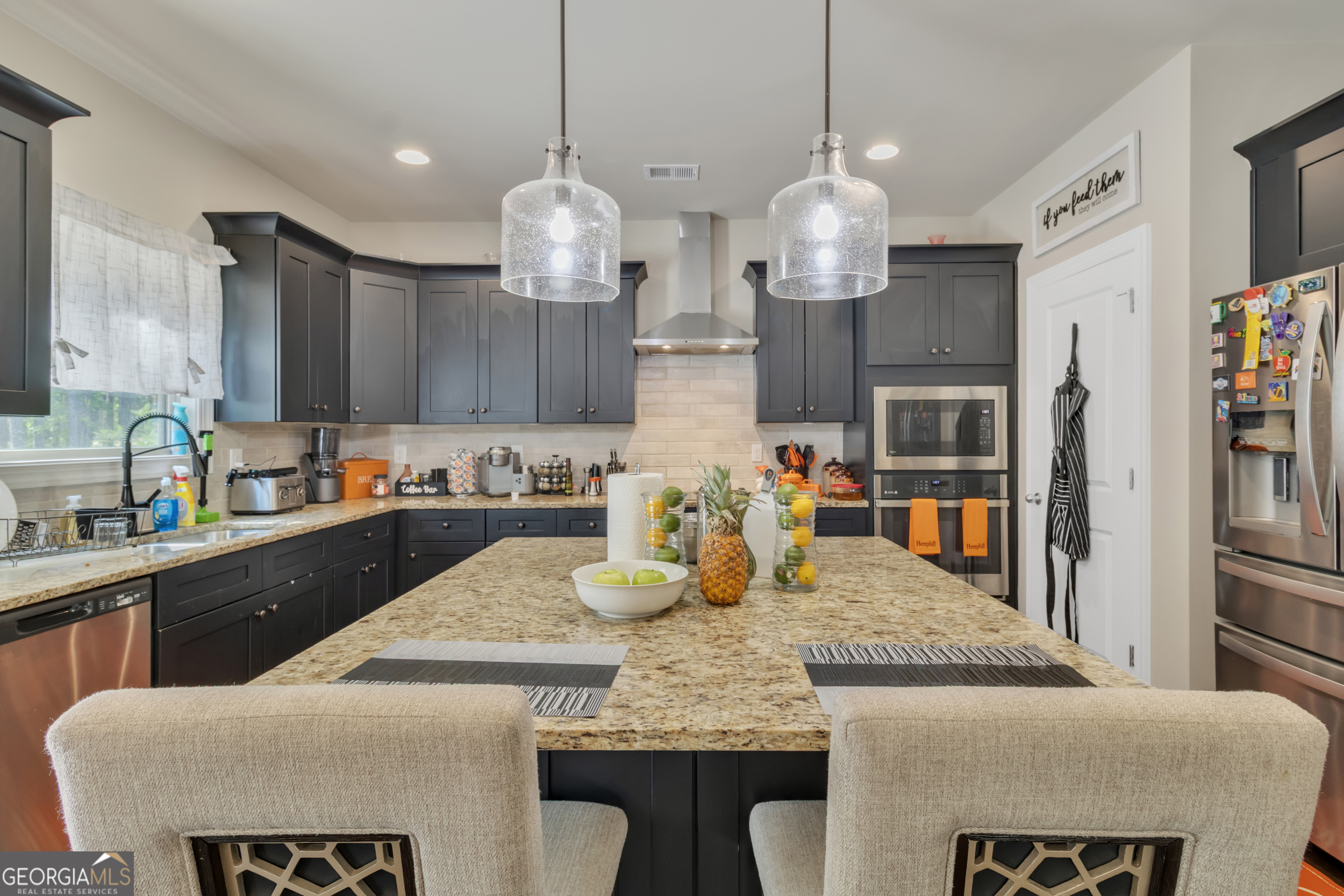 11614 Alcovy Road Covington, GA 30014 - Photo 25 of 62 a kitchen with granite countertop kitchen island stainless steel appliances and wooden floor