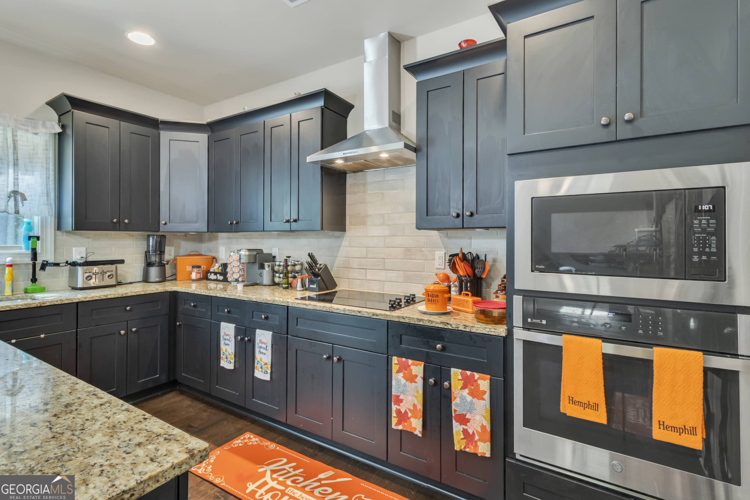 11614 Alcovy Road Covington, GA 30014 - Photo 26 of 62 a kitchen with stainless steel appliances granite countertop a stove and a sink