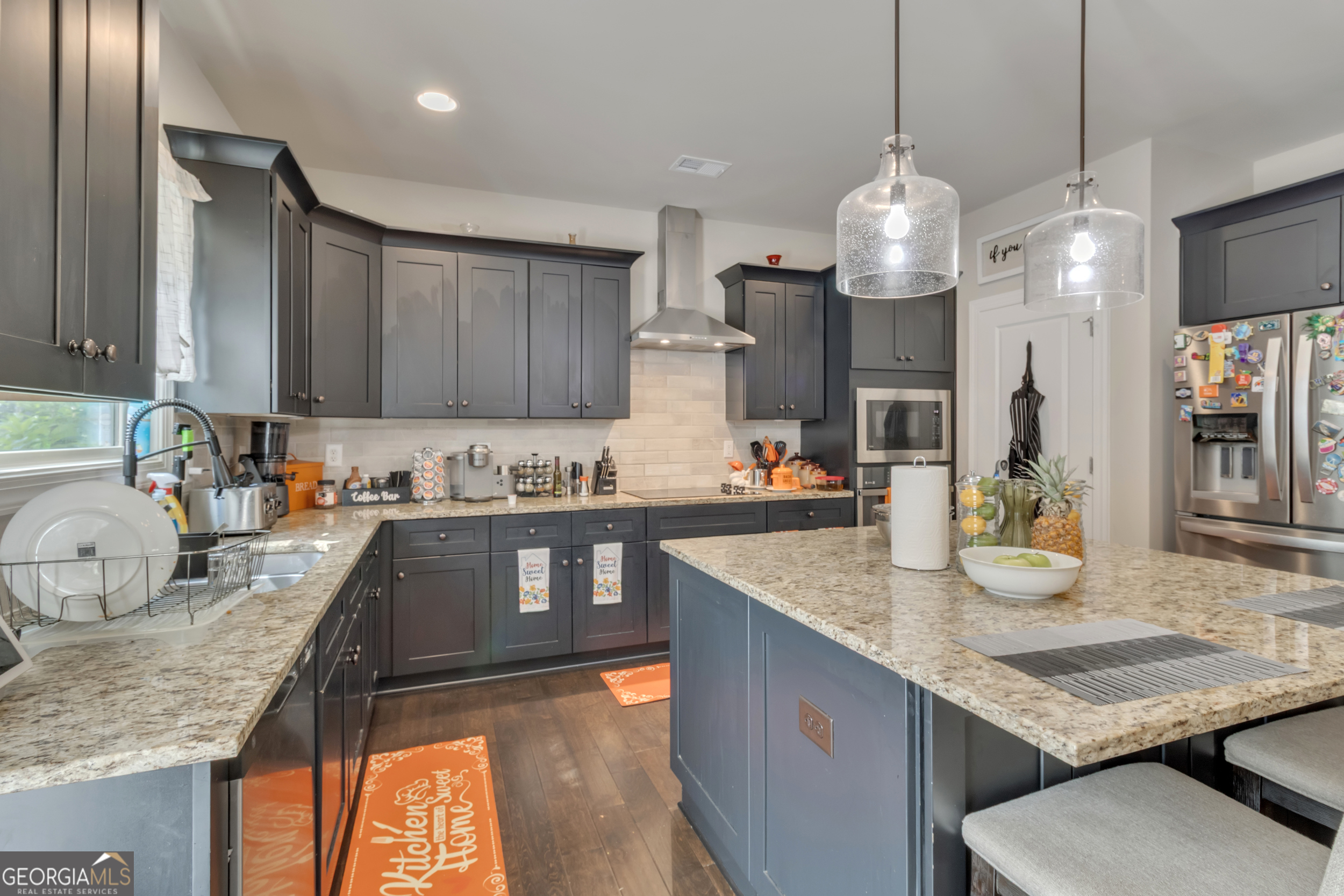 11614 Alcovy Road Covington, GA 30014 - Photo 28 of 62 a kitchen with granite countertop kitchen island stainless steel appliances a sink stove and refrigerator