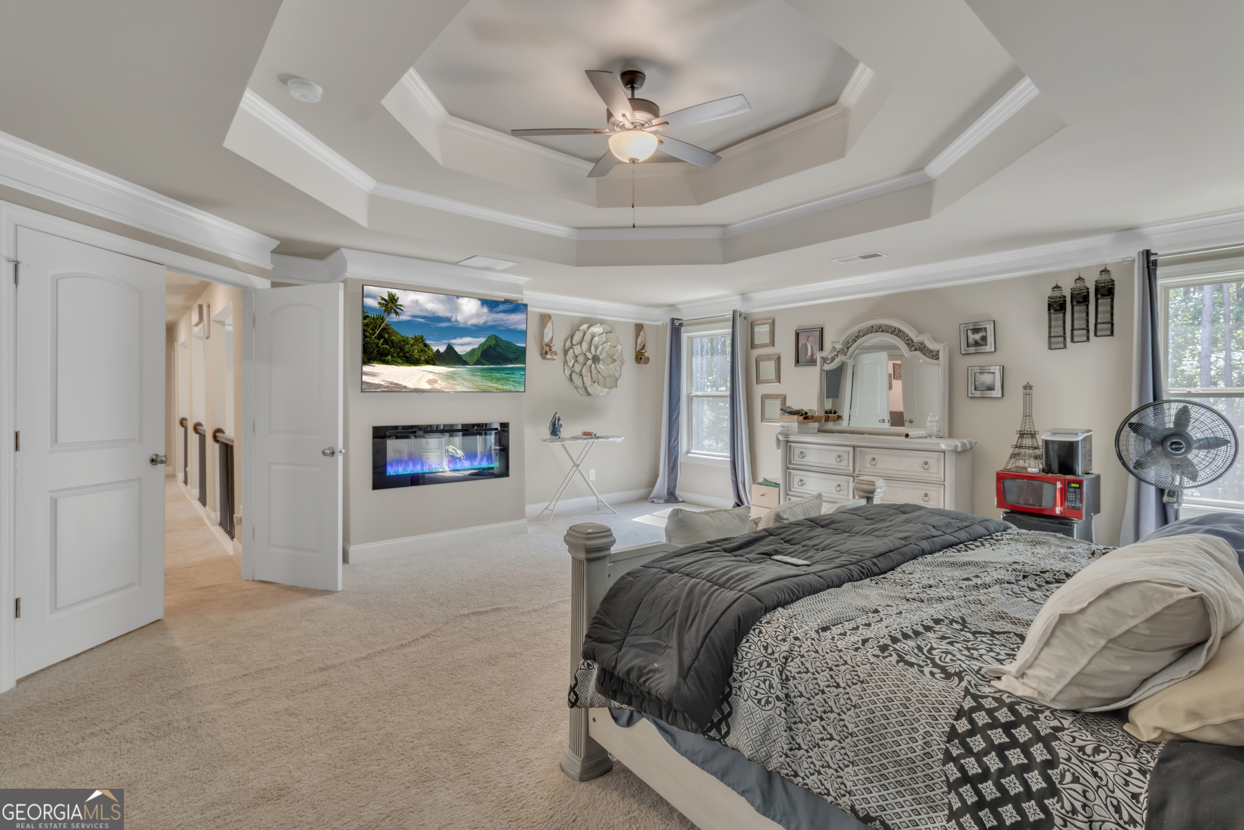 11614 Alcovy Road Covington, GA 30014 - Photo 33 of 62 a spacious bedroom with a bed a ceiling fan and a couch
