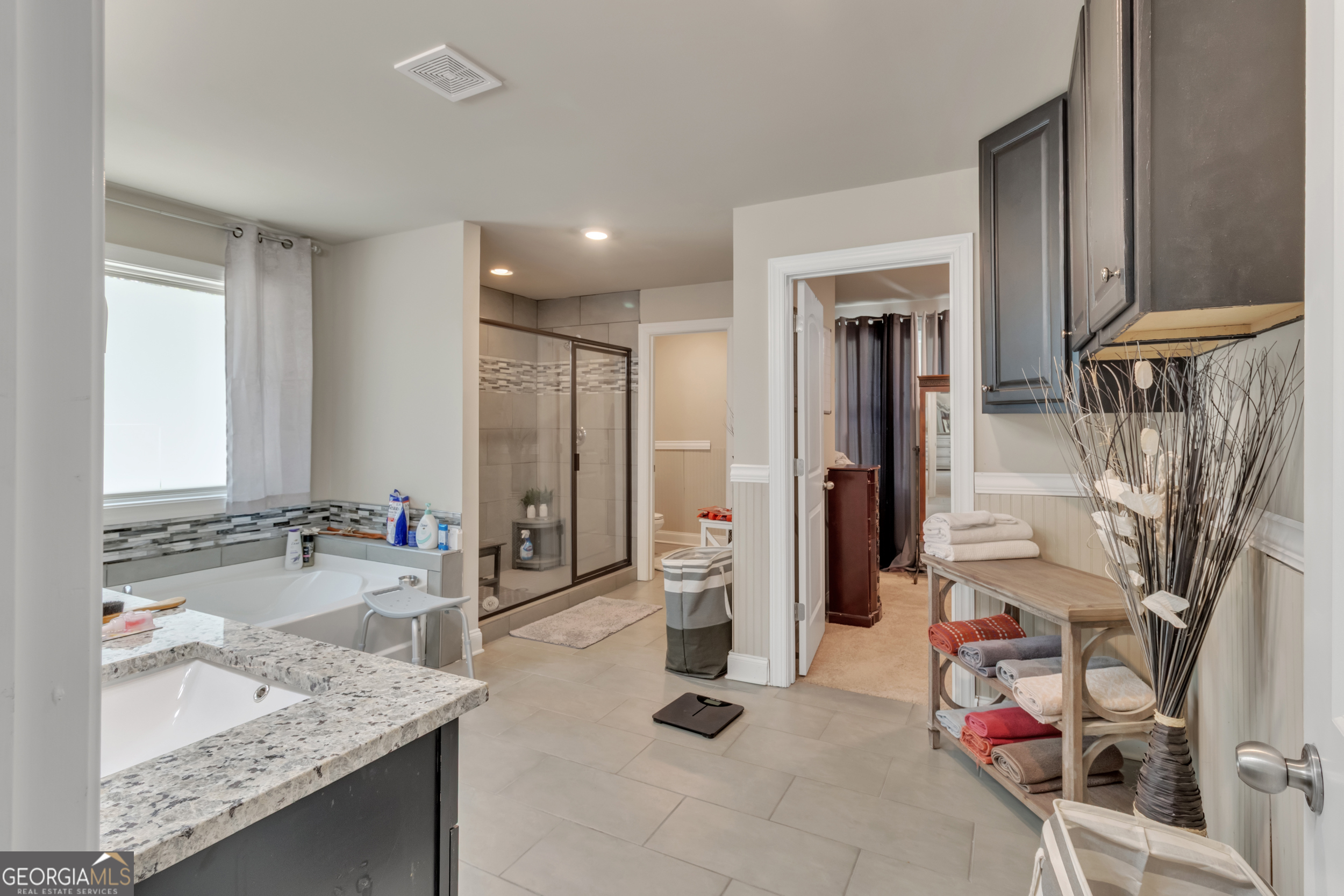 11614 Alcovy Road Covington, GA 30014 - Photo 35 of 62 a bathroom with a granite countertop sink a toilet and a bathtub