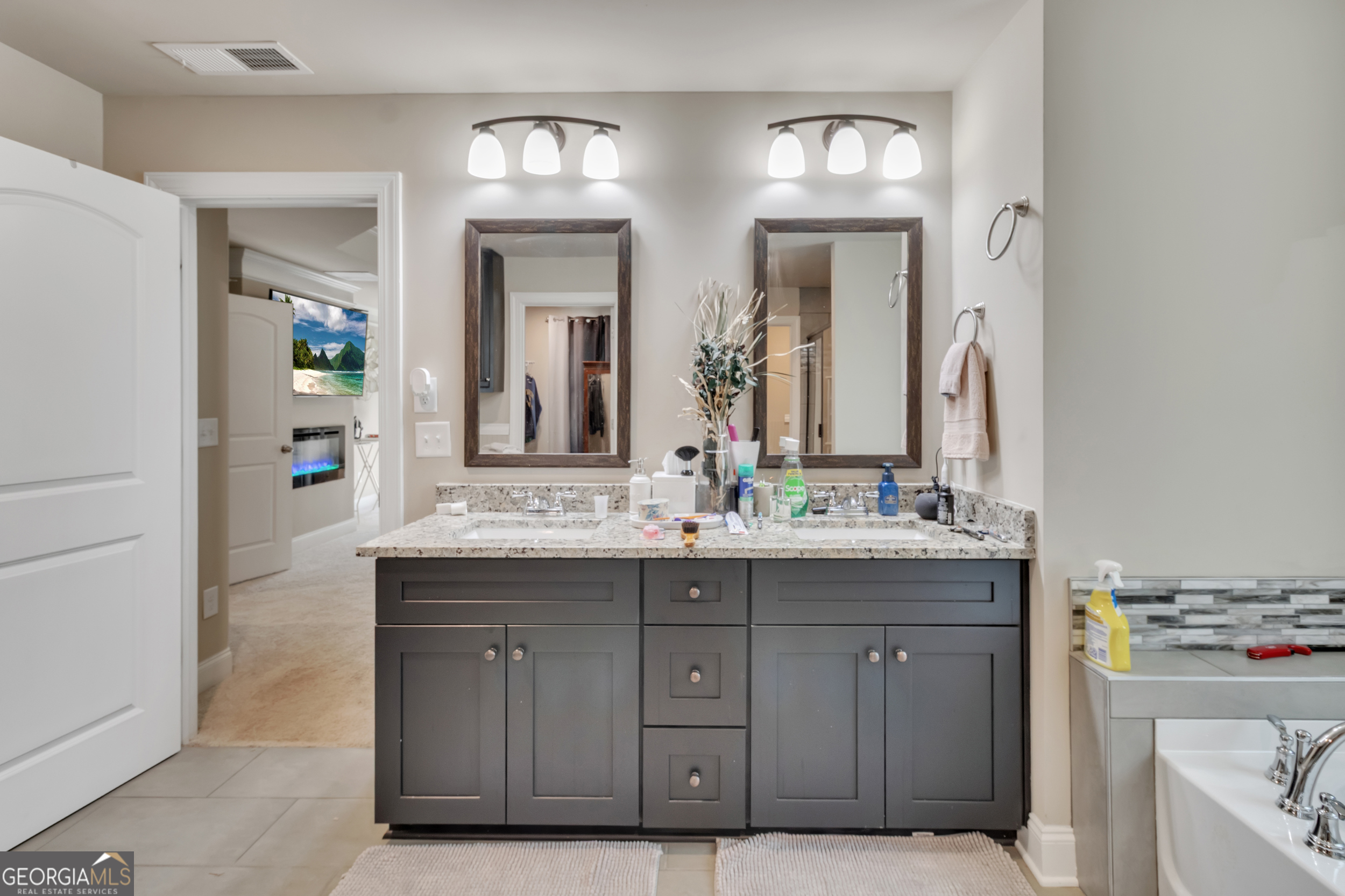 11614 Alcovy Road Covington, GA 30014 - Photo 36 of 62 a bathroom with a granite countertop sink and a mirror