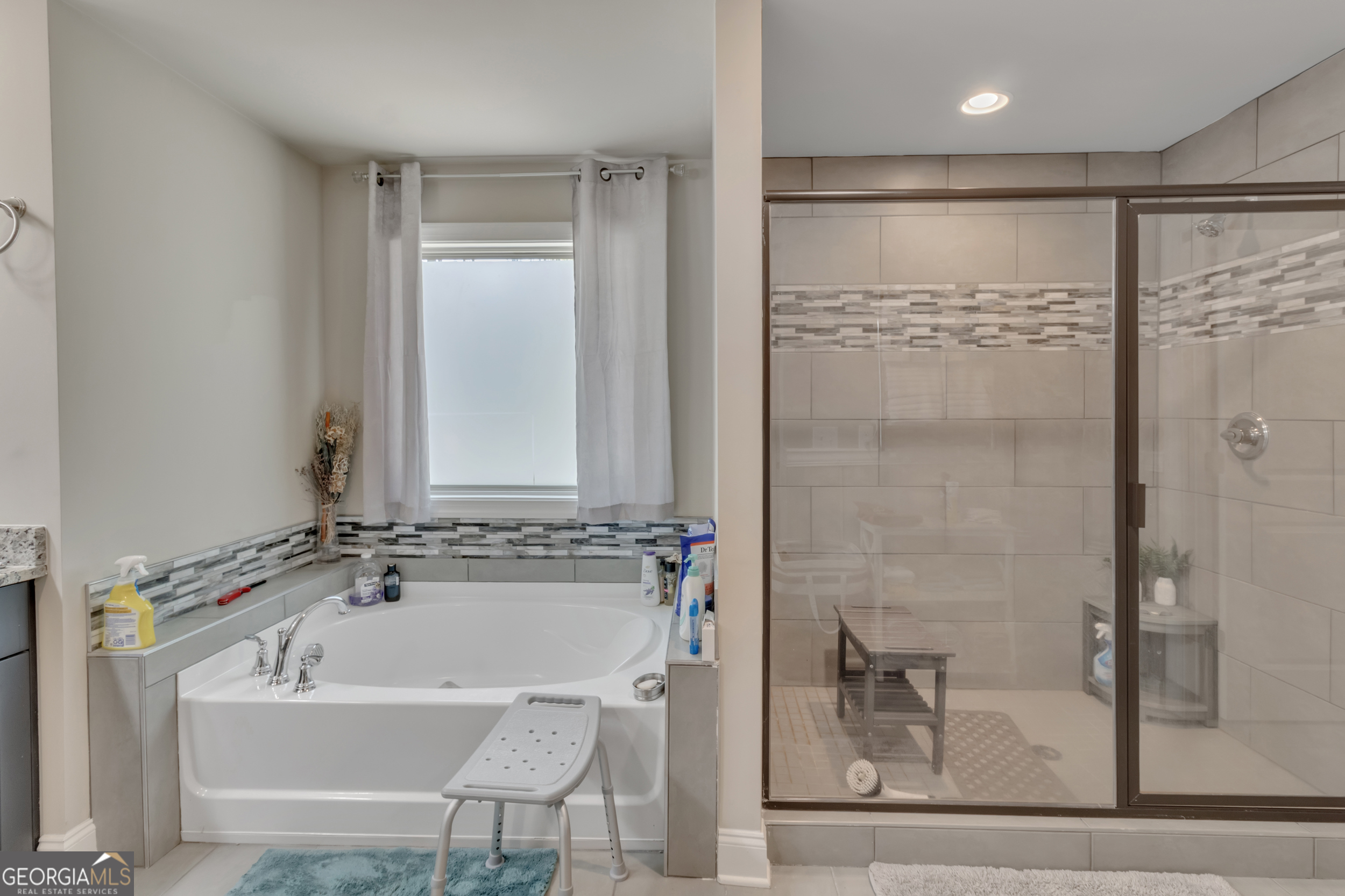11614 Alcovy Road Covington, GA 30014 - Photo 37 of 62 a bathroom with a bathtub and a shower