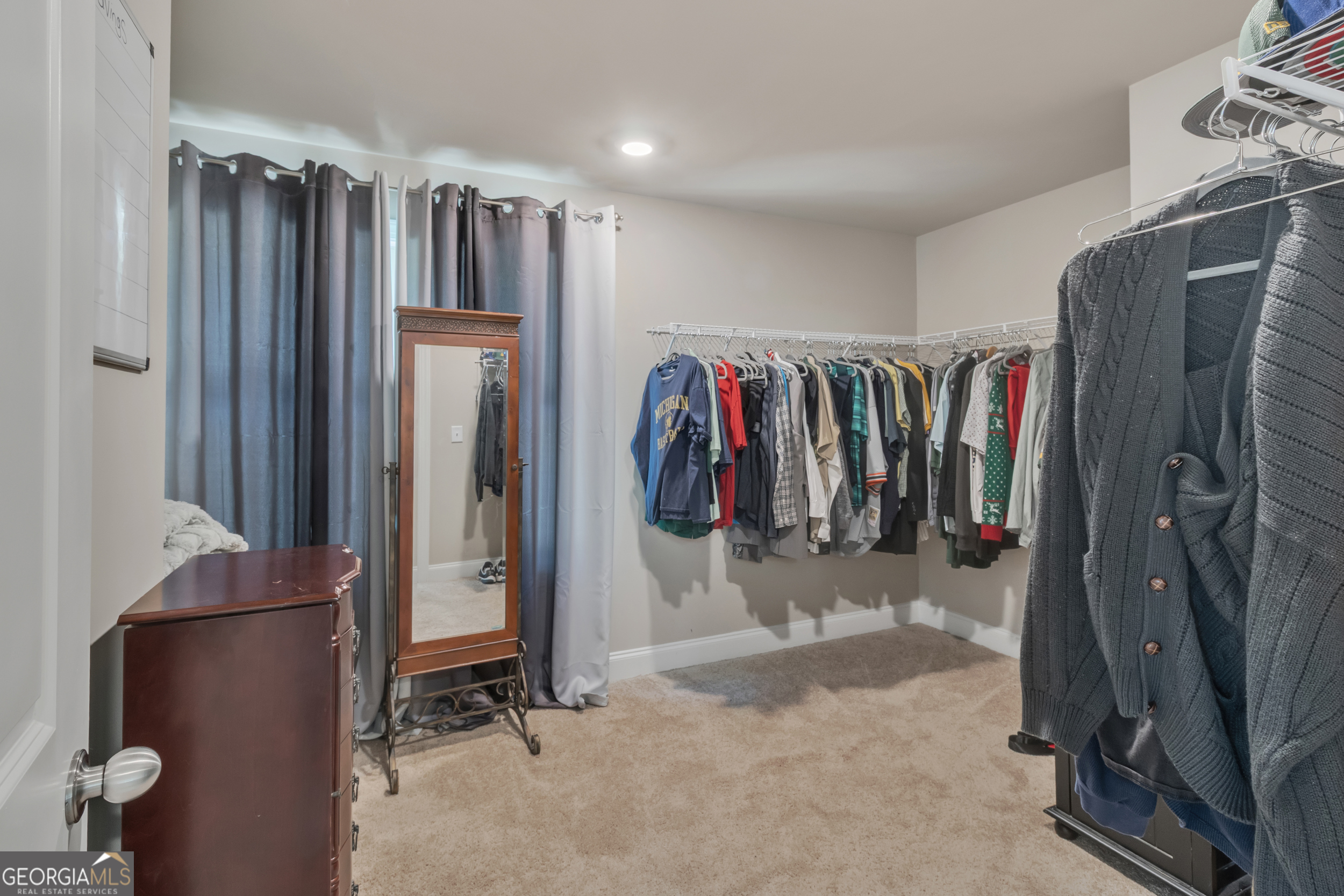 11614 Alcovy Road Covington, GA 30014 - Photo 38 of 62 a view of walk in closet with clothes