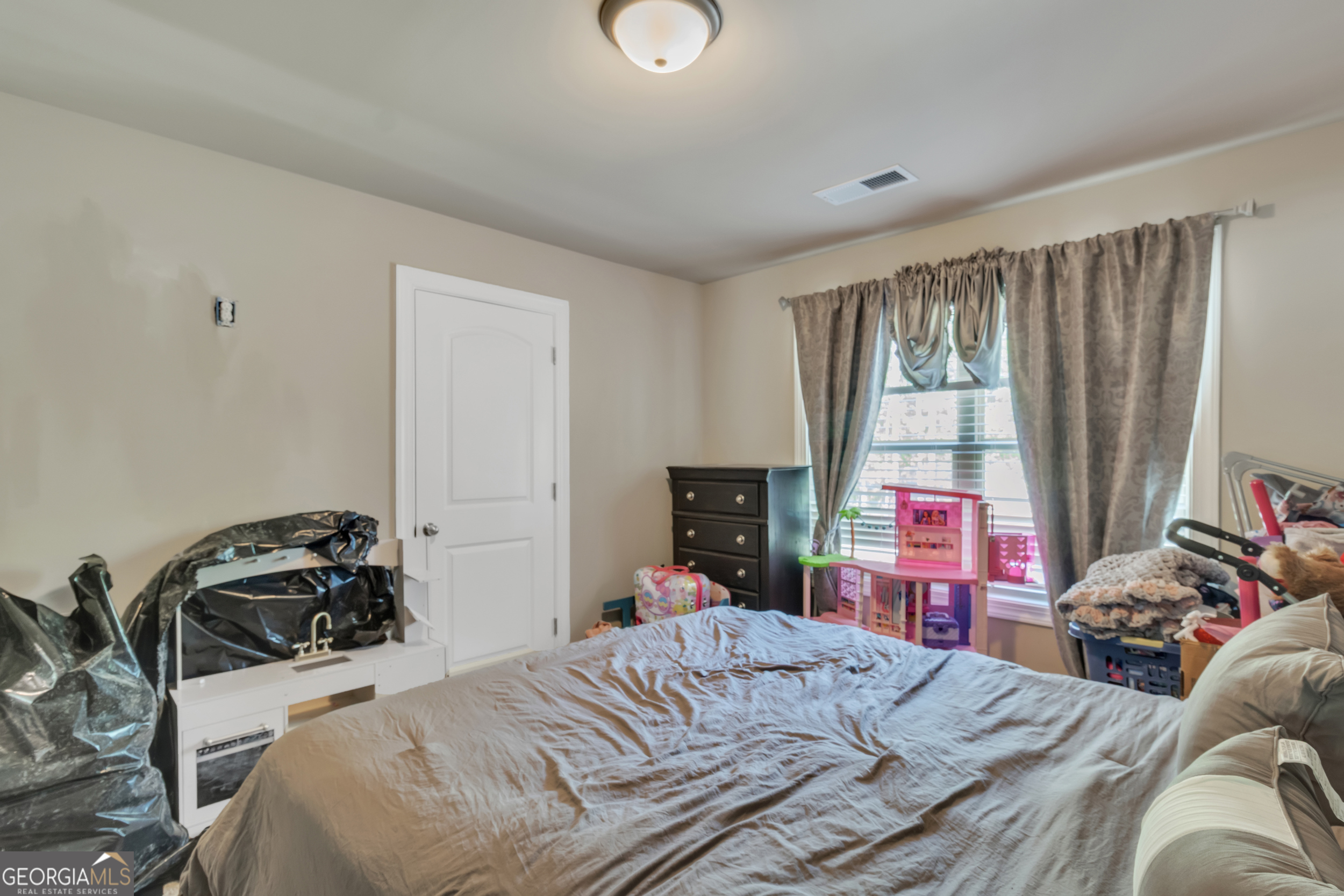 11614 Alcovy Road Covington, GA 30014 - Photo 46 of 62 a bedroom with a bed and a window
