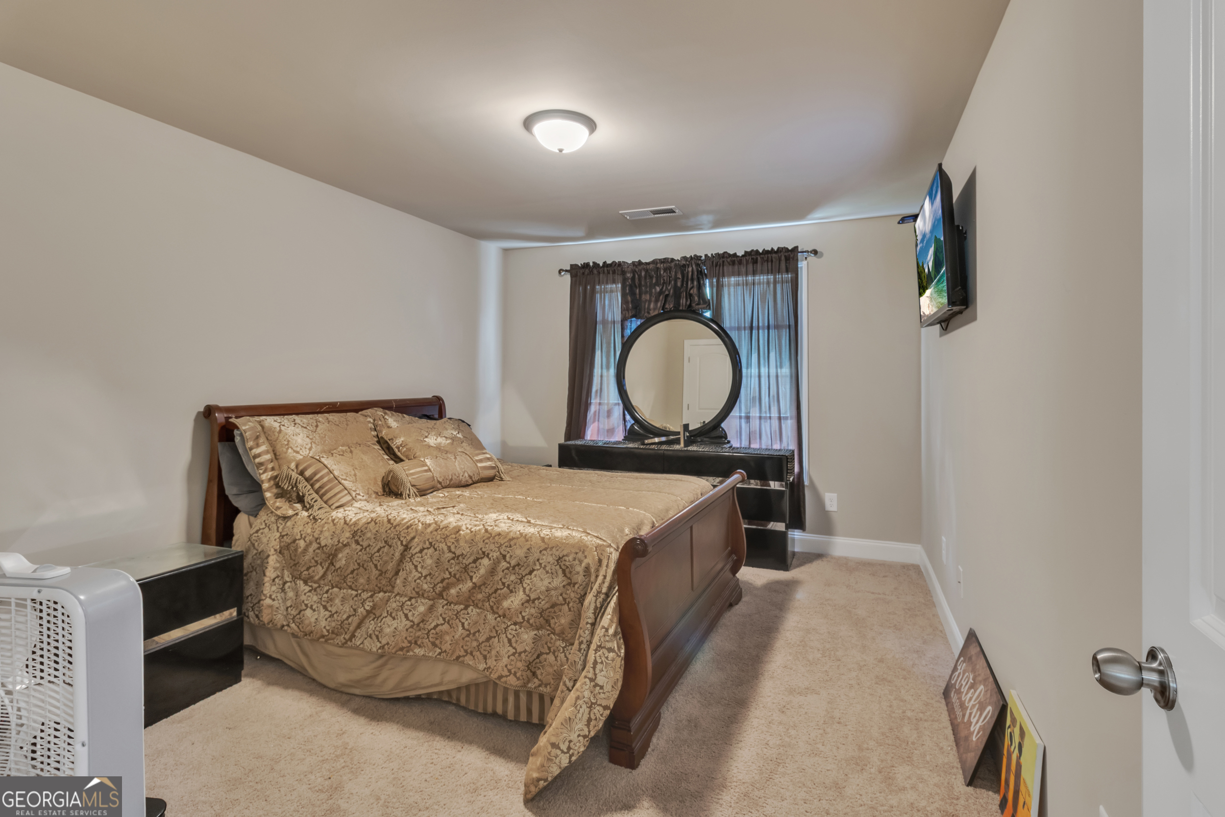 11614 Alcovy Road Covington, GA 30014 - Photo 50 of 62 a bedroom with a bed and wooden floor