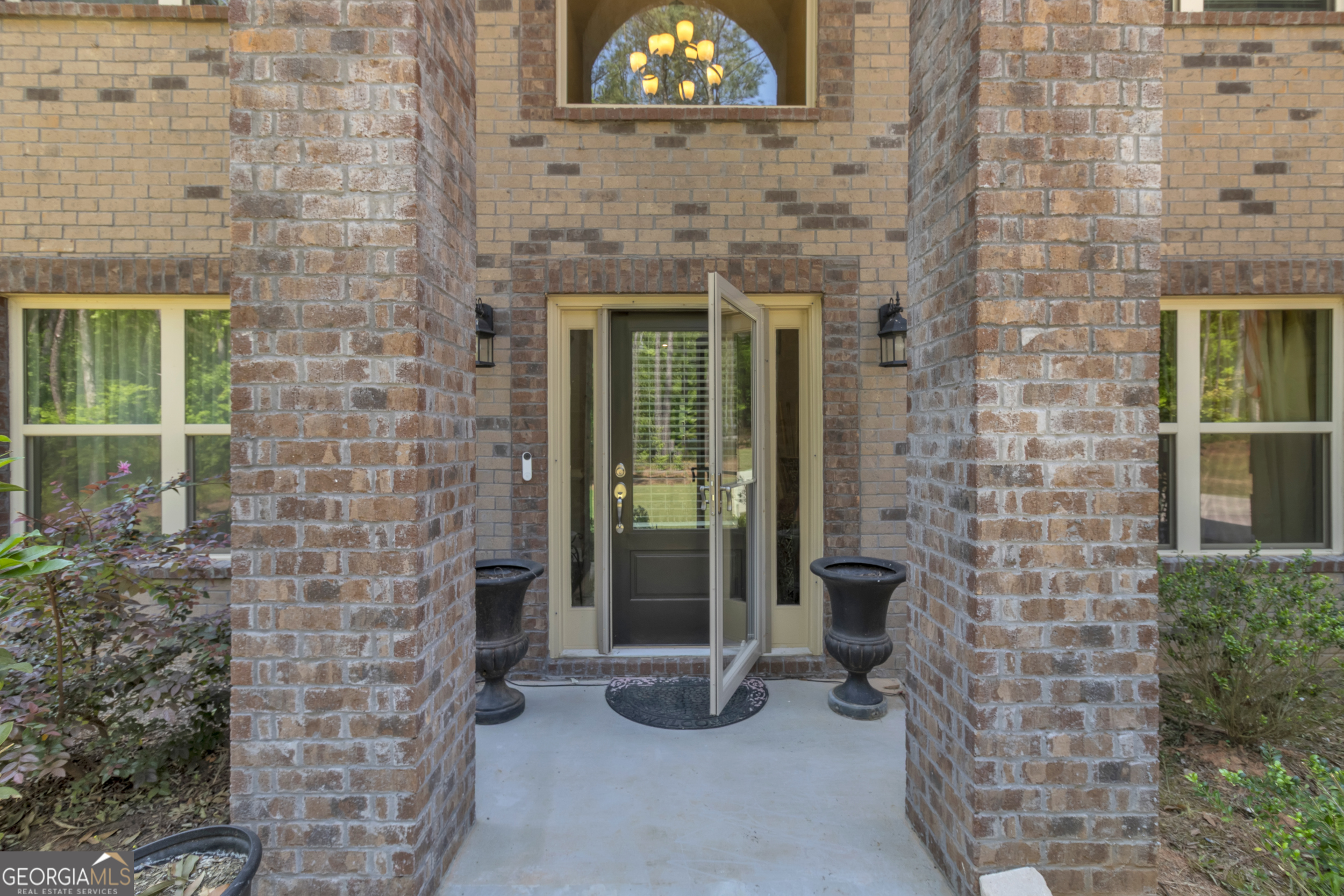 11614 Alcovy Road Covington, GA 30014 - Photo 7 of 62 a brick building with a bench in front of it