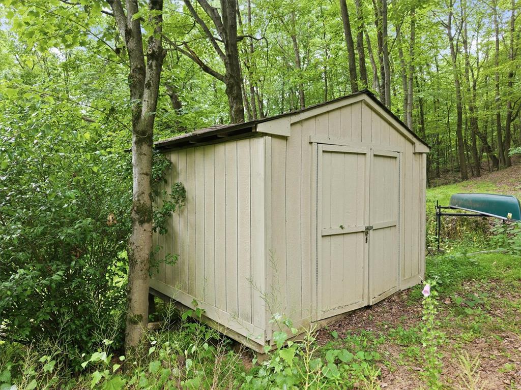 520 Highland Hill Road Jim Thorpe, PA 18235 - Photo 66 of 83 A quaint storage shed nestled amidst lush greenery offers practical outdoor utility.