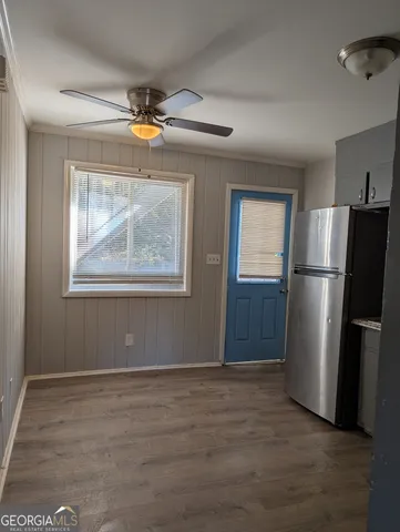 a view of empty room with wooden floor and cabinet