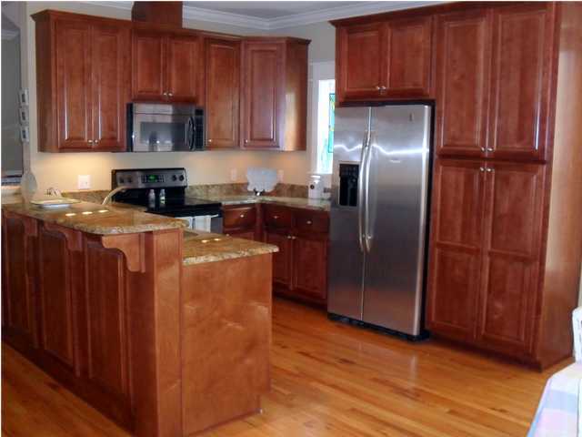 203 Seacrest Beach Boulevard East Seacrest, FL 32461 - Photo 2 of 24 a kitchen with stainless steel appliances granite countertop wood cabinets and a refrigerator
