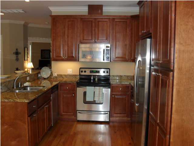 203 Seacrest Beach Boulevard East Seacrest, FL 32461 - Photo 3 of 24 a kitchen with kitchen island granite countertop stainless steel appliances stove and cabinets