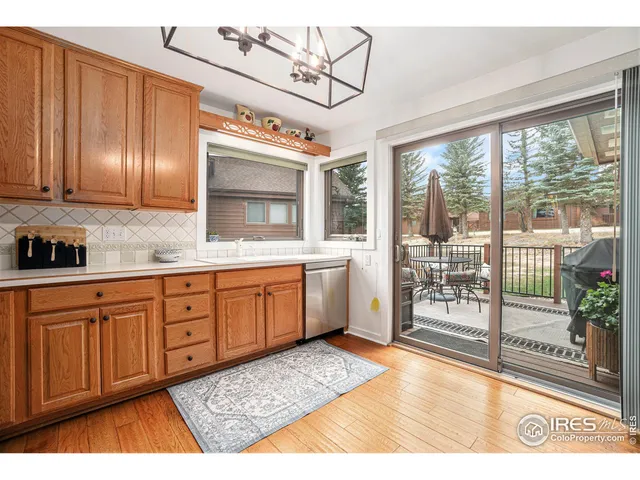 a spacious bathroom with a granite countertop sink a mirror and next to a window