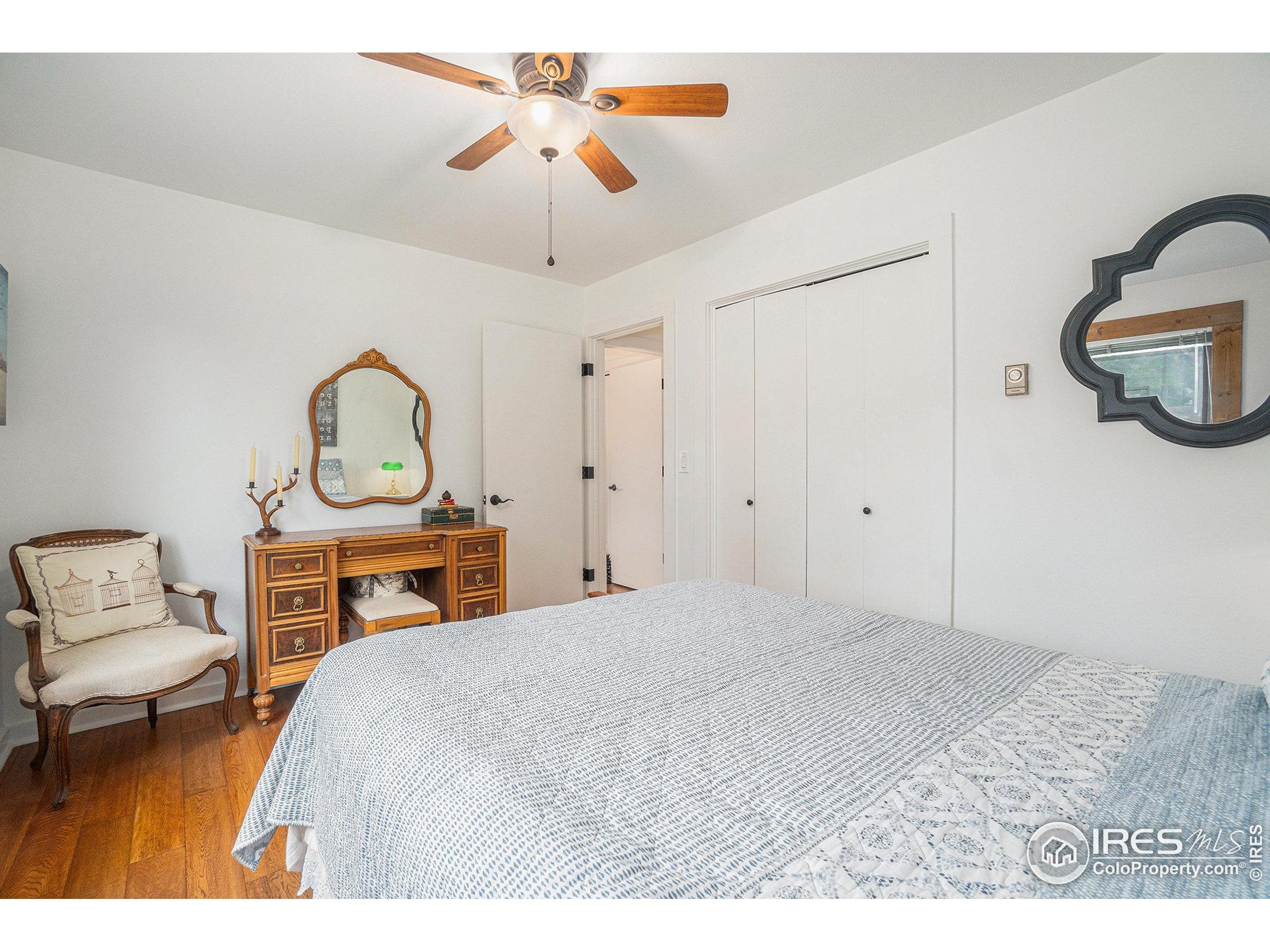 1422 Matthew Circle, Unit 2 Estes Park, CO 80517 - Photo 19 of 30 a bedroom with a bed a chandelier and dresser