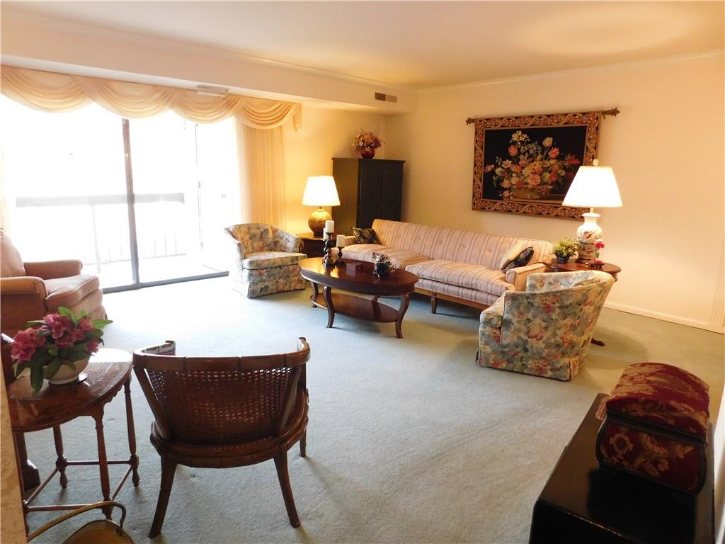 1500 Cochran Road, Unit 611 Pittsburgh, PA 15243 - Photo 6 of 25 Spacious living room bathed in light through the oversized sliding glass doors leading to one of the two balconies.