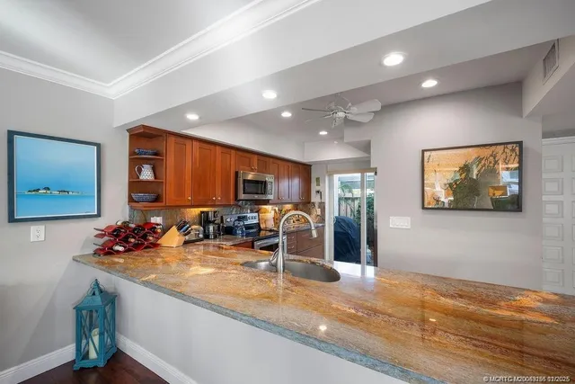 a kitchen with a stove a sink and a microwave