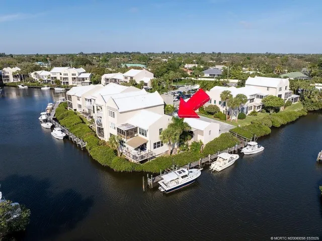 a view of a lake with lawn chairs