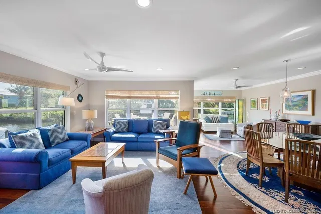 a living room with furniture large window and a table