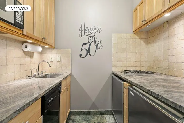 a bathroom with a granite countertop sink toilet tub and shower