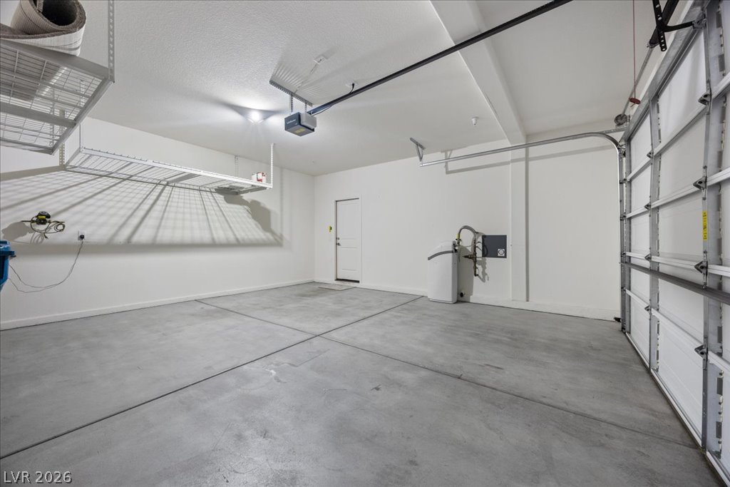 2572 Sable Ridge Street Henderson, NV 89044 - Photo 52 of 83 Roomy 2 car finished garage with storage racks above... water softener too!