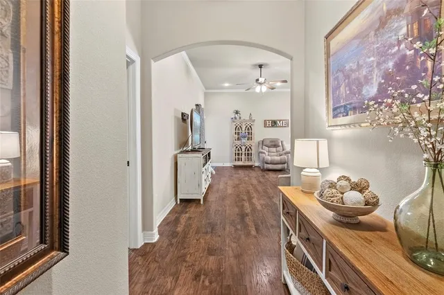 a living room with furniture kitchen view and a chandelier