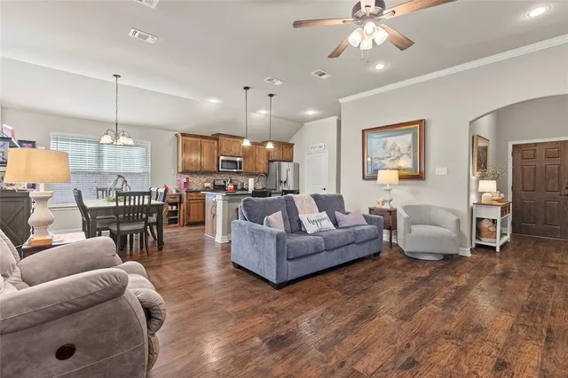 a kitchen with stainless steel appliances granite countertop a refrigerator sink and stove