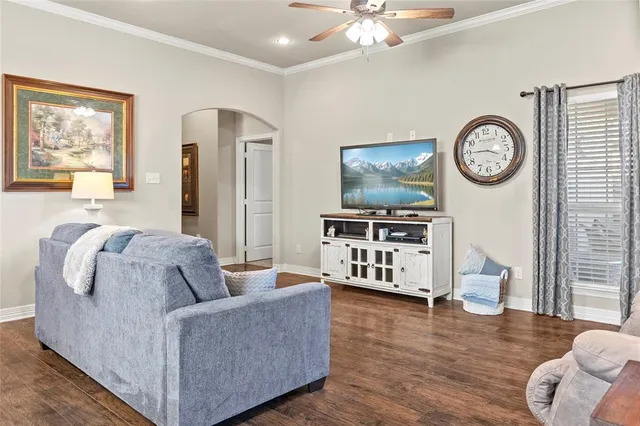 a kitchen with stainless steel appliances granite countertop a stove top oven a sink dishwasher a dining table and chairs with wooden floor