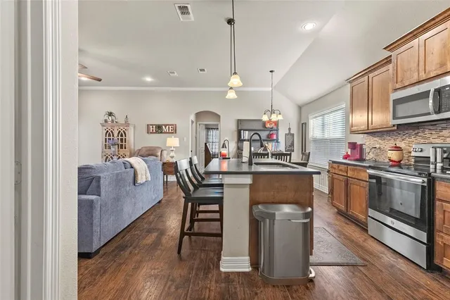 a bedroom with bed and paintings on the wall