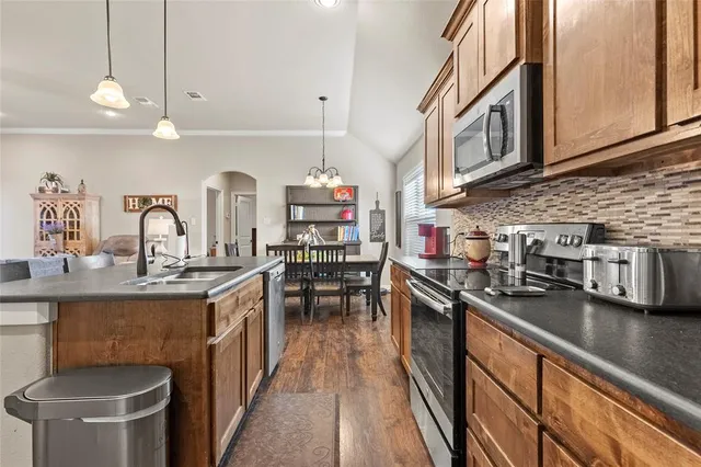 a bathroom with a granite countertop sink a mirror a bathtub and shower