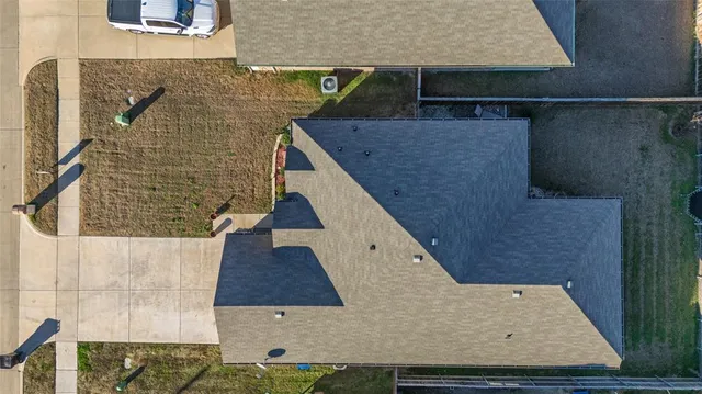 an aerial view of a house with a yard