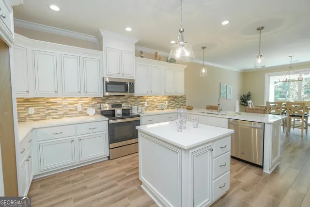 a kitchen with a sink stove cabinets and refrigerator