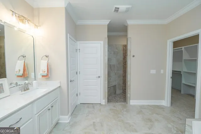 a spacious bathroom with a double vanity sink a mirror and a shower