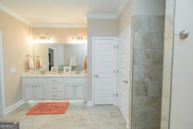 a spacious bathroom with a granite countertop sink and a mirror