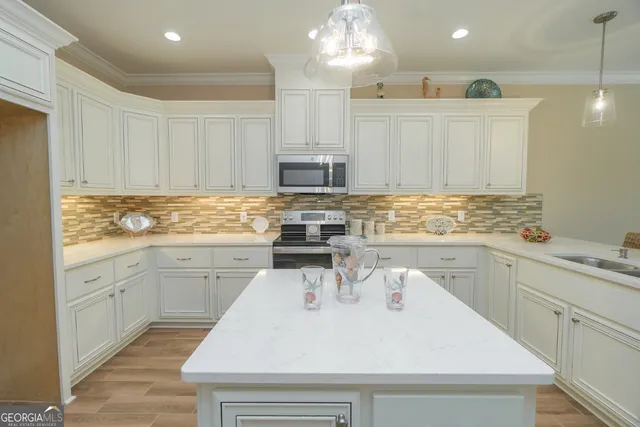 a kitchen with a sink stove and cabinets