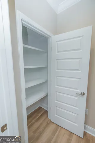a view of walk in closet with empty racks