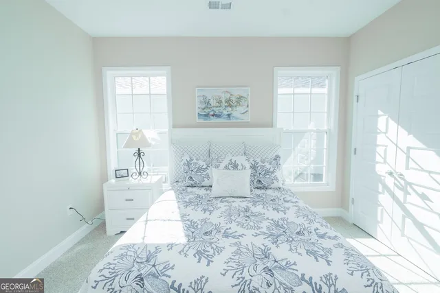 a bedroom with a large bed and a dresser