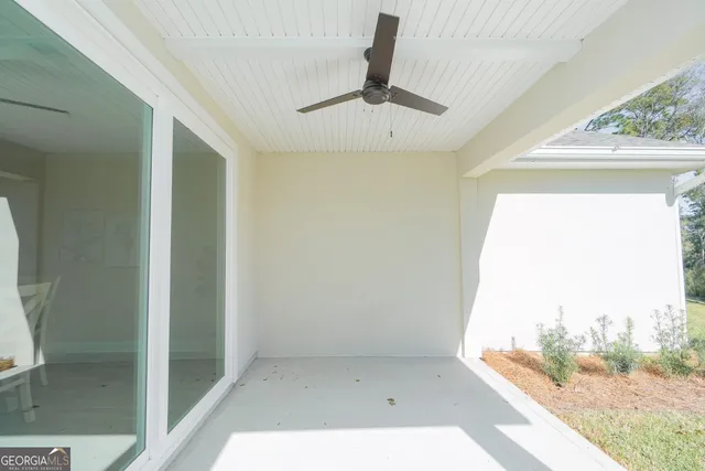 a view of a glass door and porch with a floor to ceiling window
