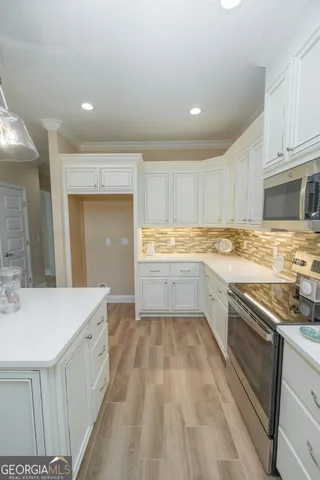 a kitchen with a sink stove and cabinets